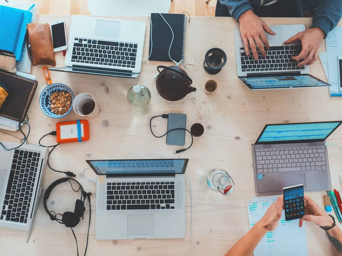 Laptops and notebooks on a shared work table